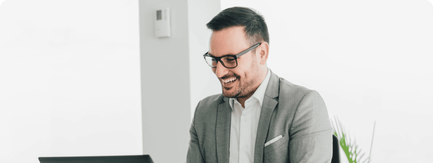 business man smiling at laptop